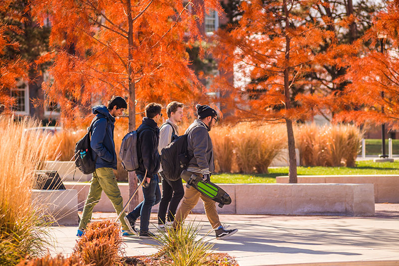 Students strolling campus in the fall