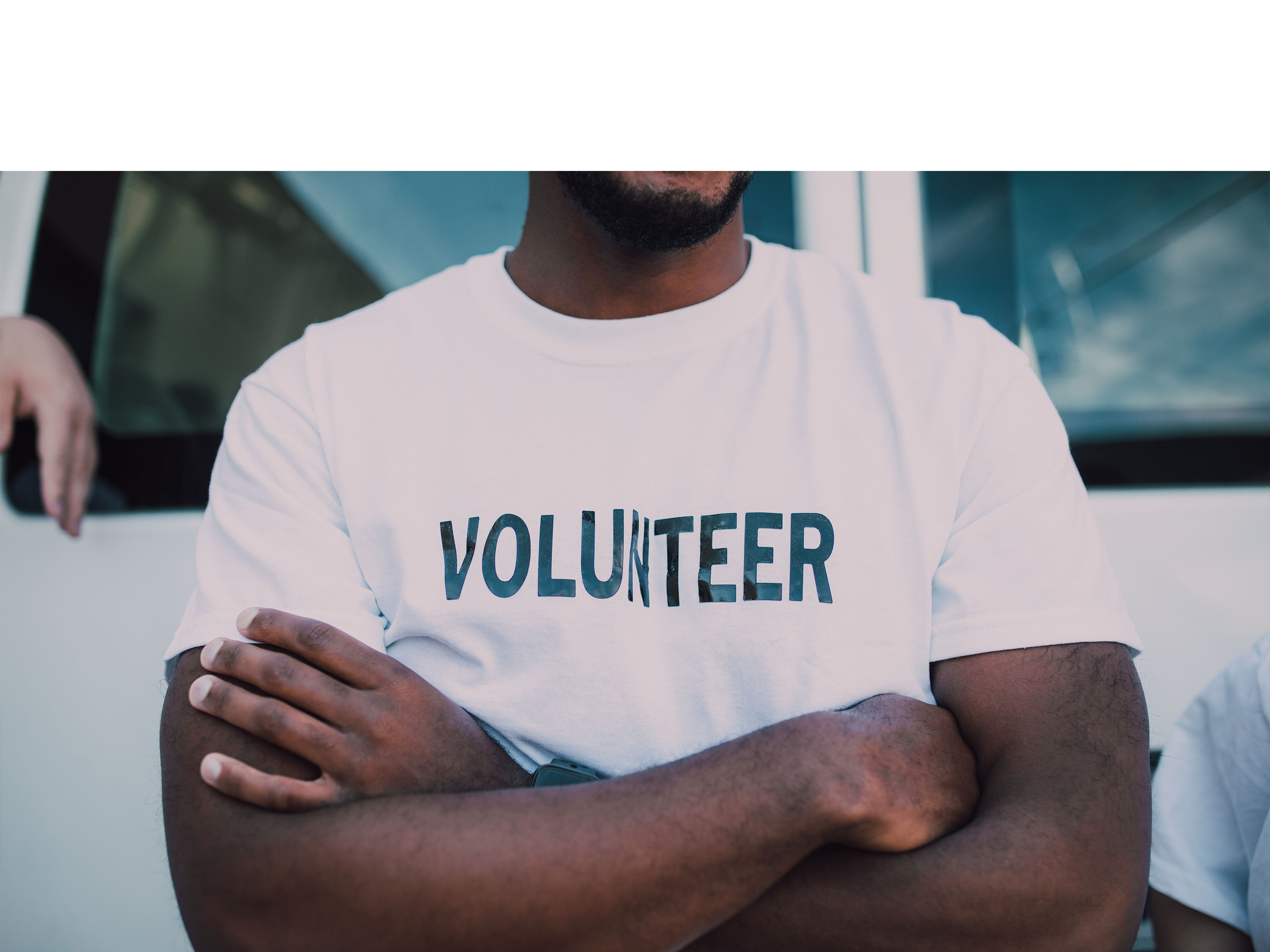Man wearing shirt that says Volunteer