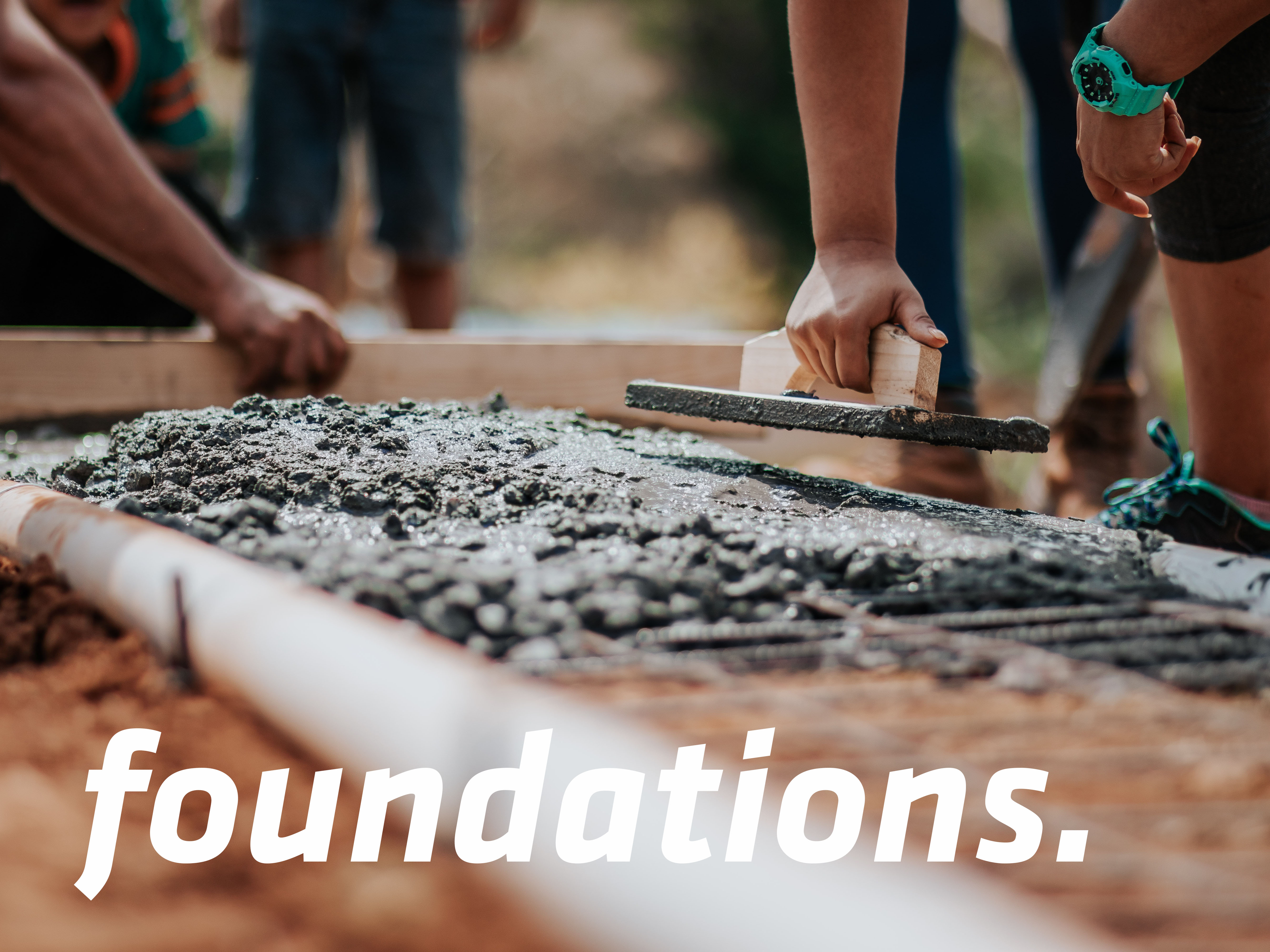 people laying concrete with trowels and the word foundations