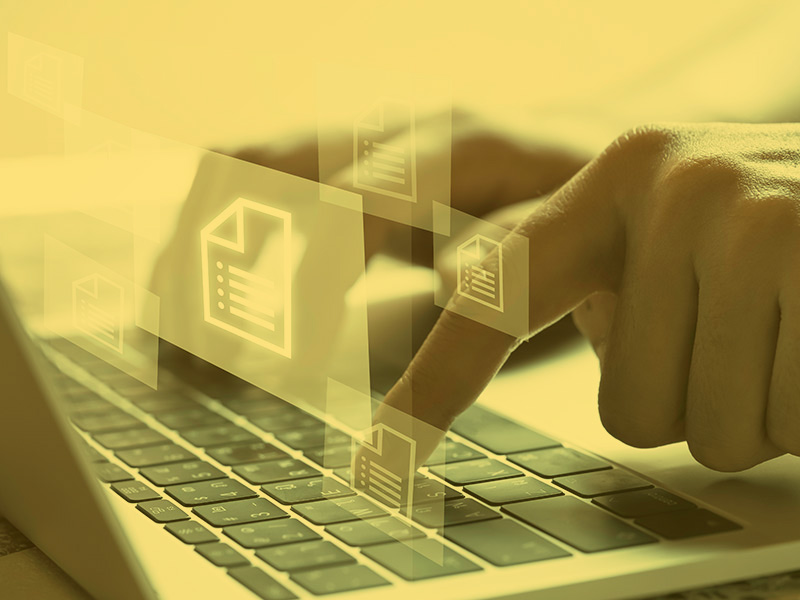 Hand with document icons and typing to laptop computer 
