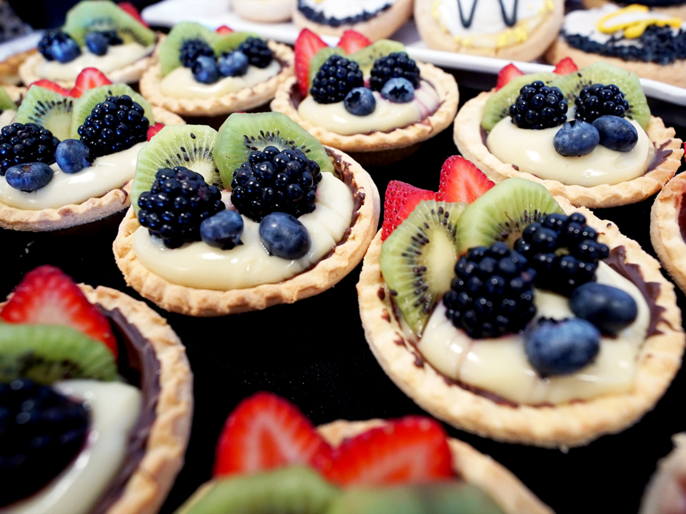 Various fruit tarts on display.