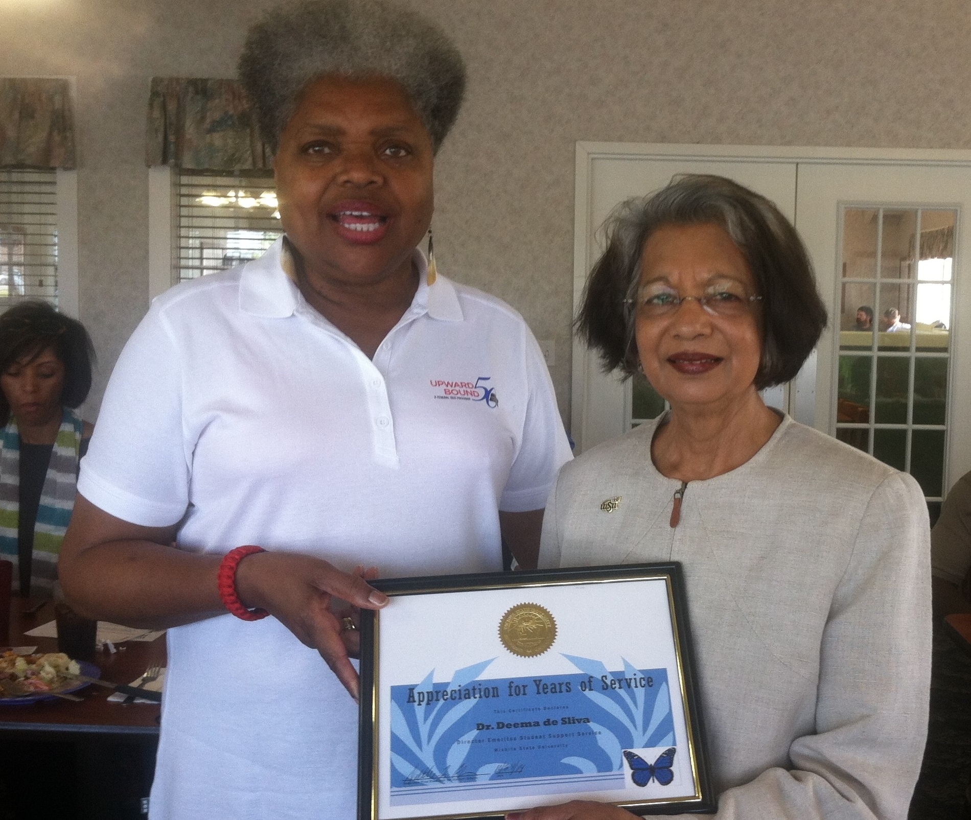 Photo of Dr. Deema de Silva's induction as a Student Support Services Director Emeritus. 