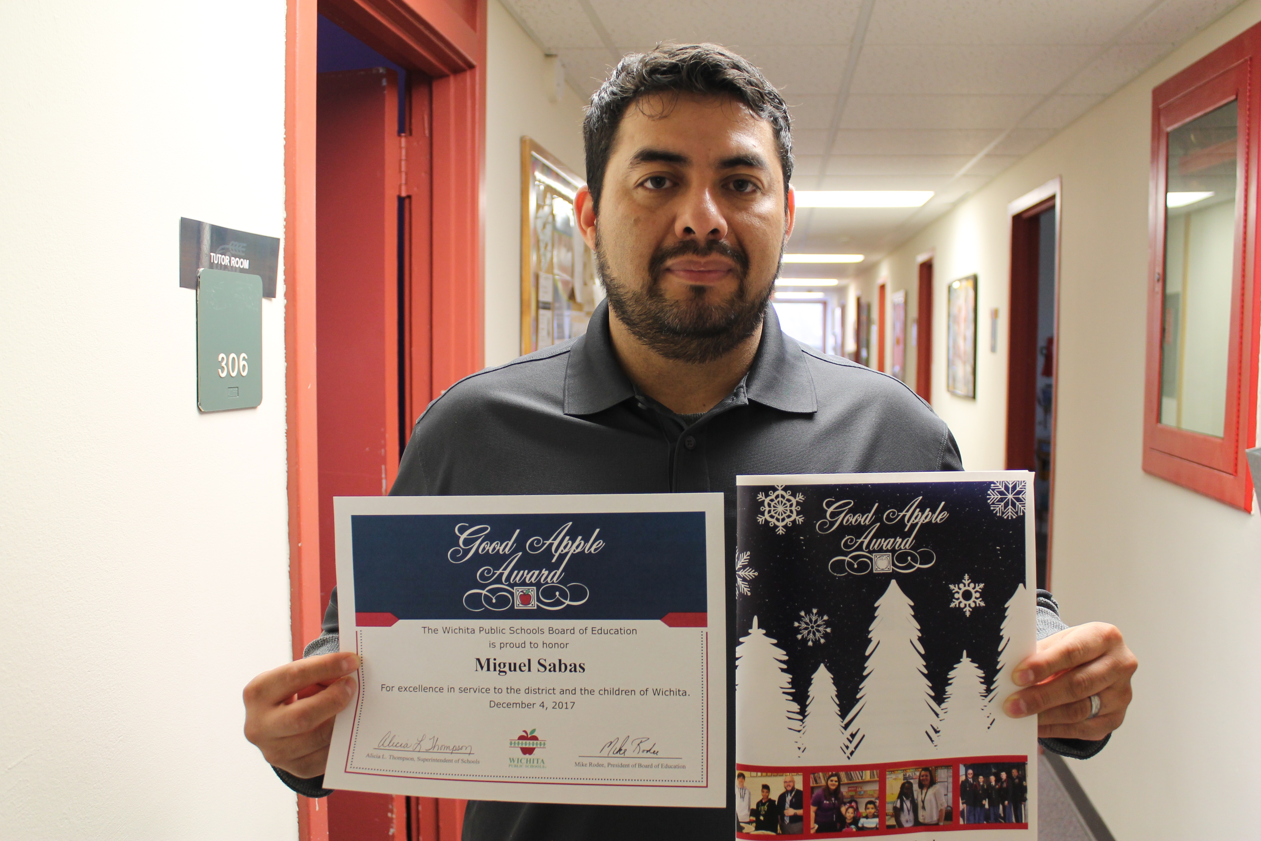 Photo of Miguel Sabas with his Good Apple Award. 