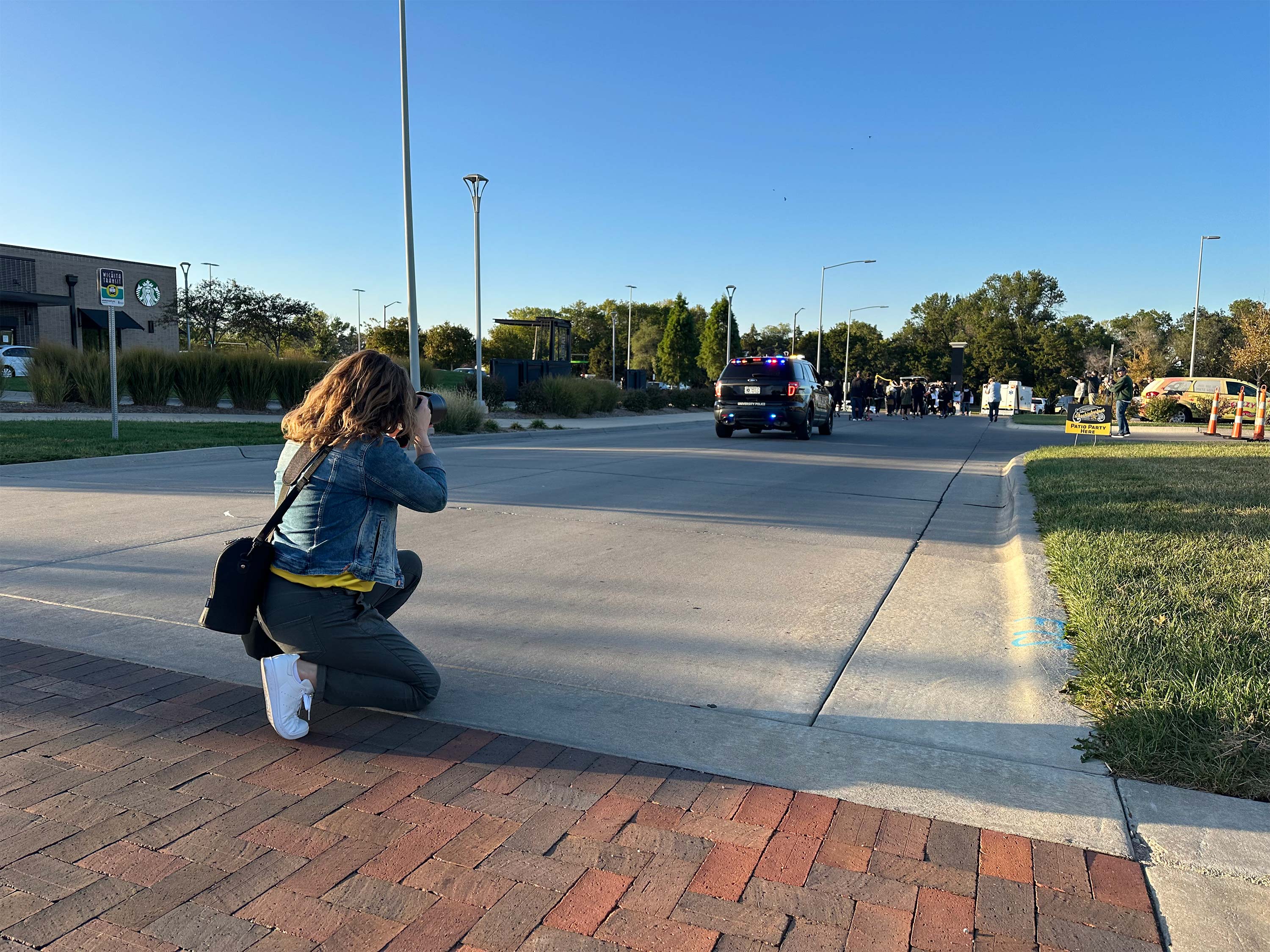 Strategic Communications senior designer snaps photos at the Shocktoberfest parade