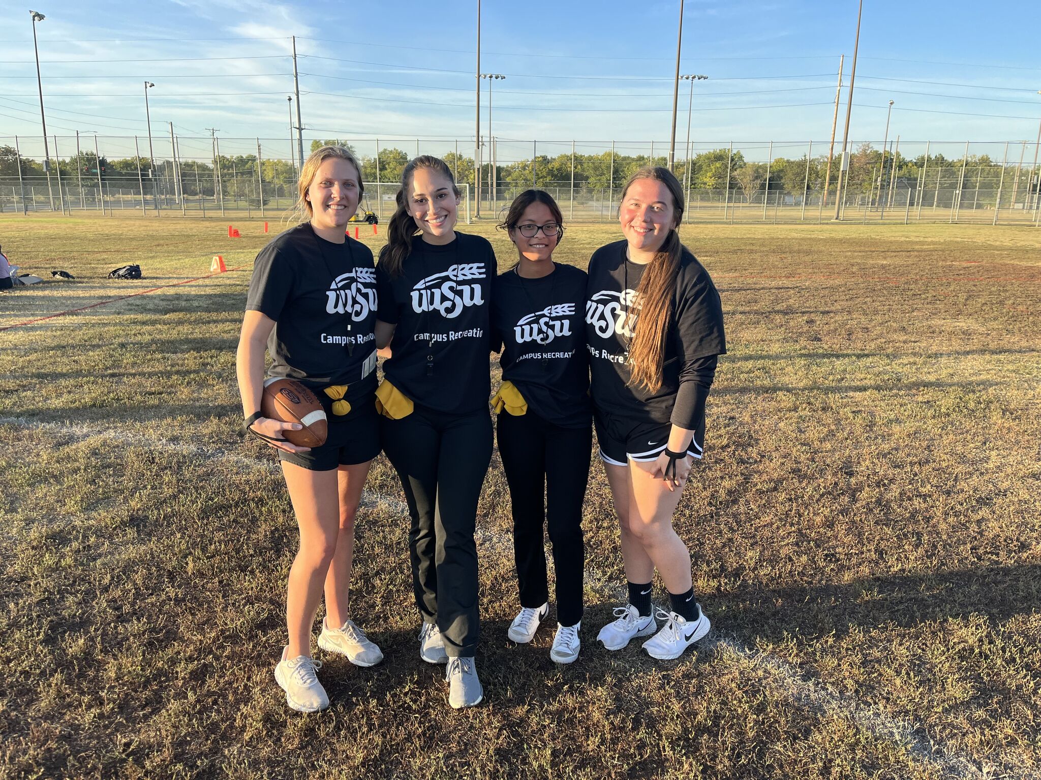 Four girls standing in a field