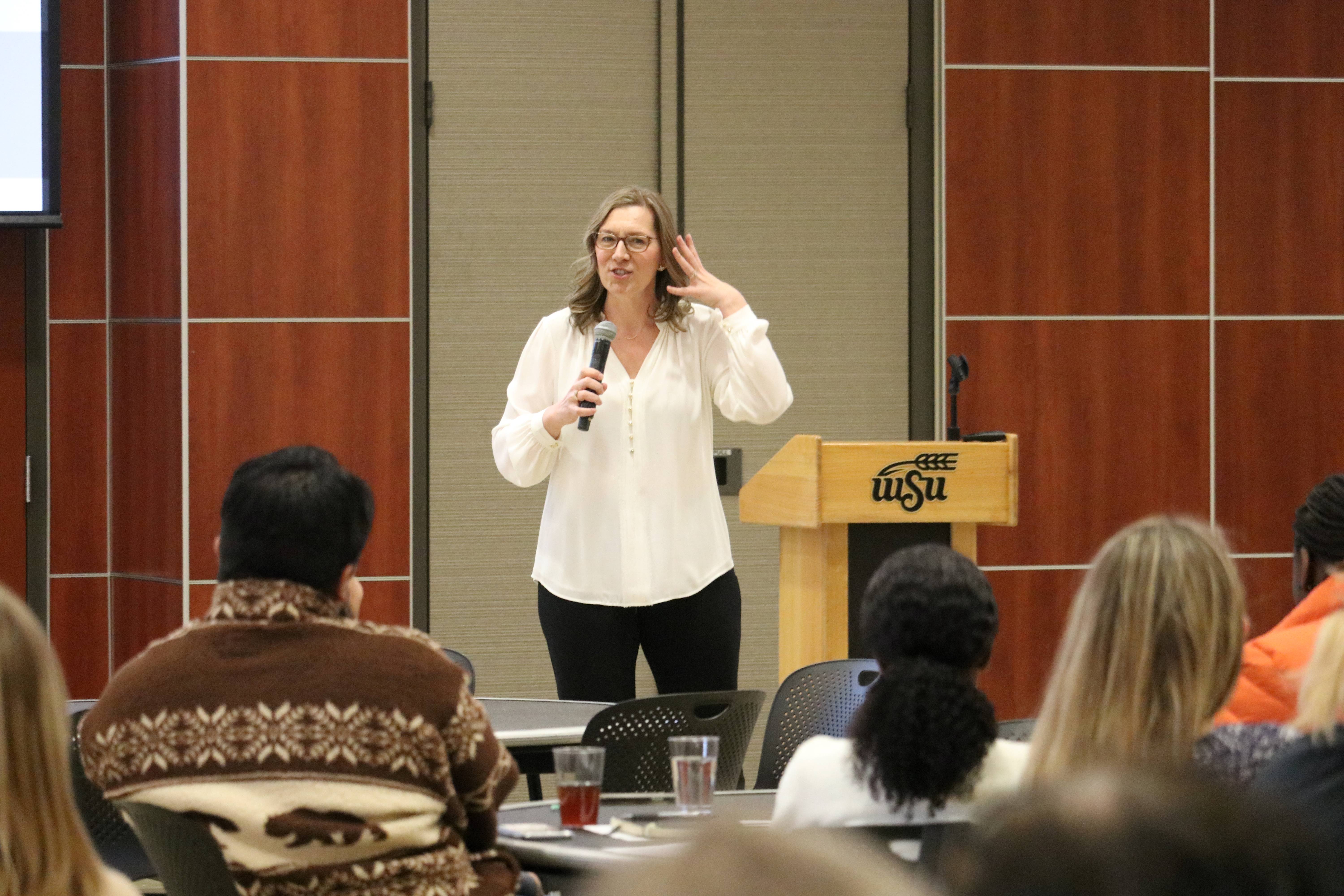Dr. Carrie Petr in front of audience