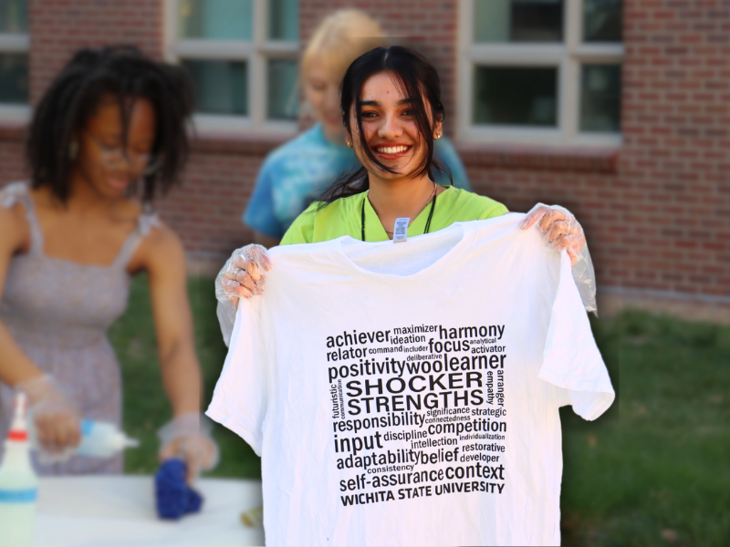 girl holding t-shirt