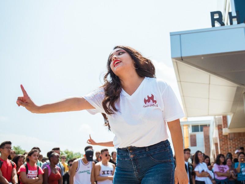 female student performing at multicultural greek council yard show