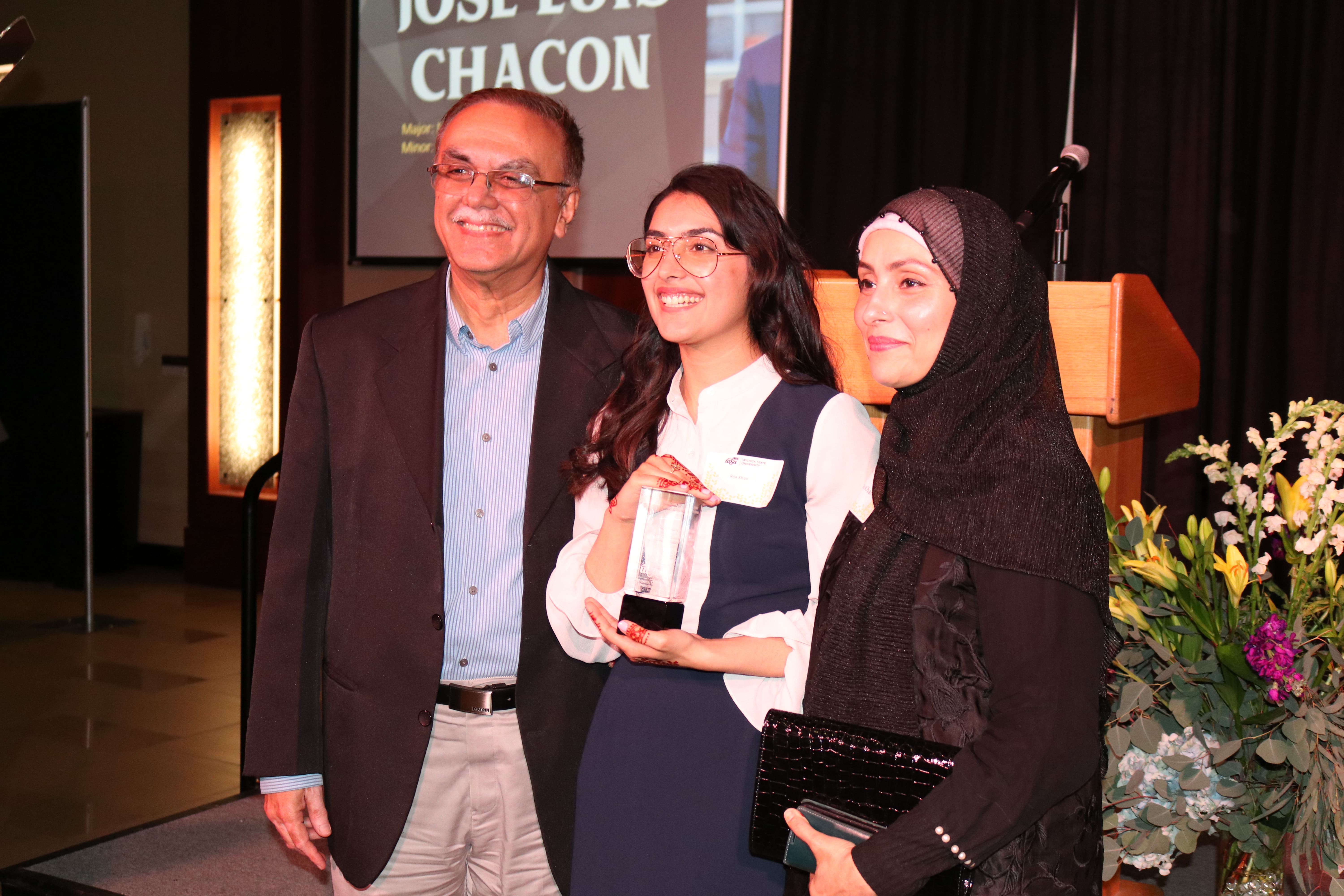 Award honoree posing for the camera along with her guests