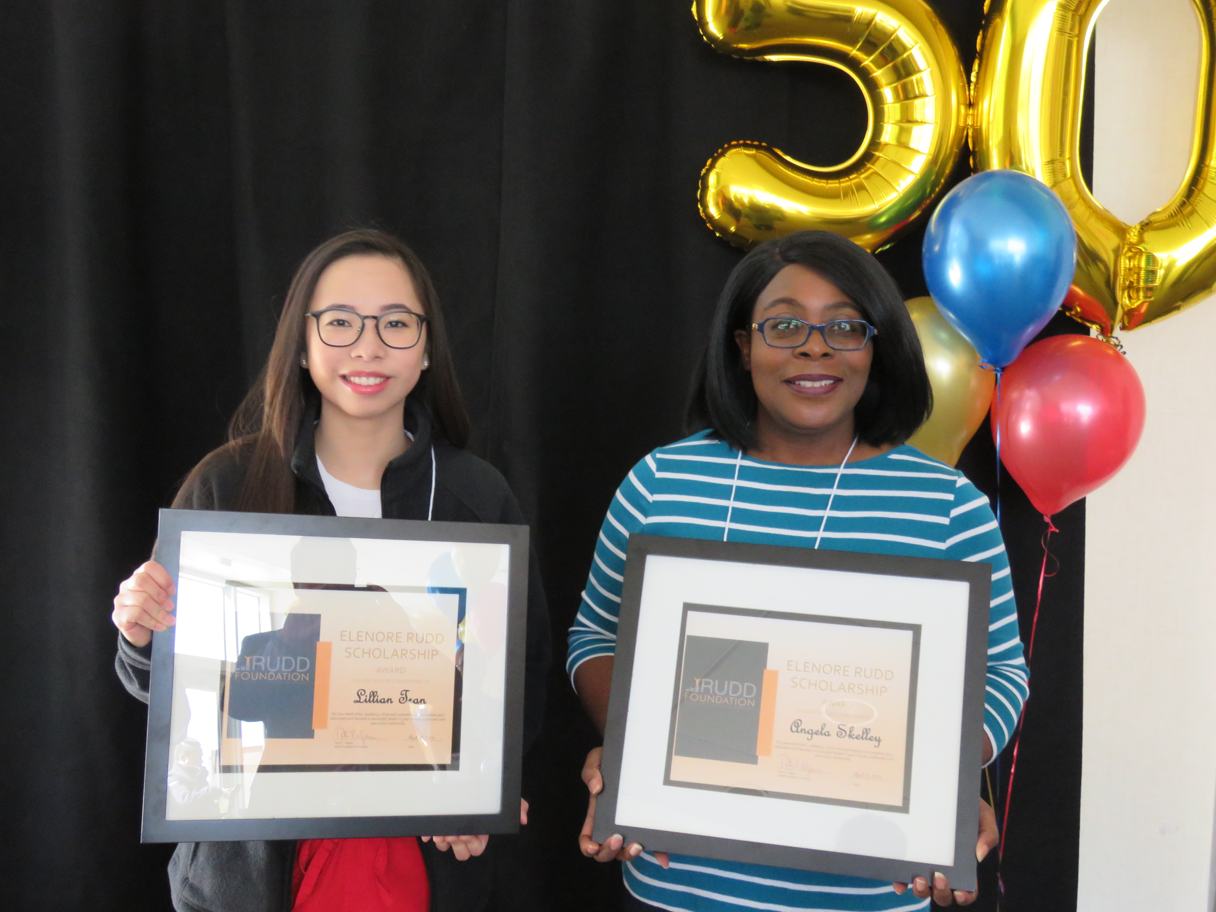 Picture of Two students display scholarship awards