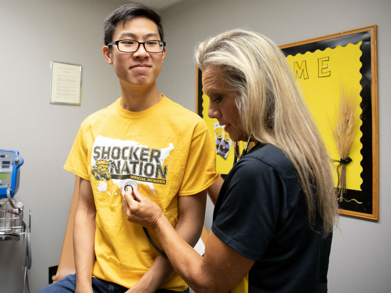 nurse listening to students heart