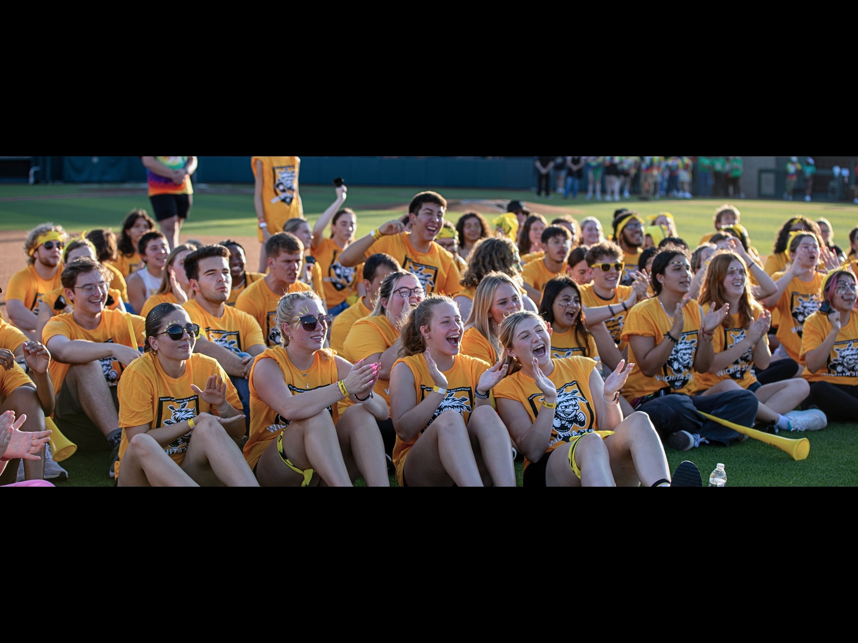 students sitting and cheering at clash