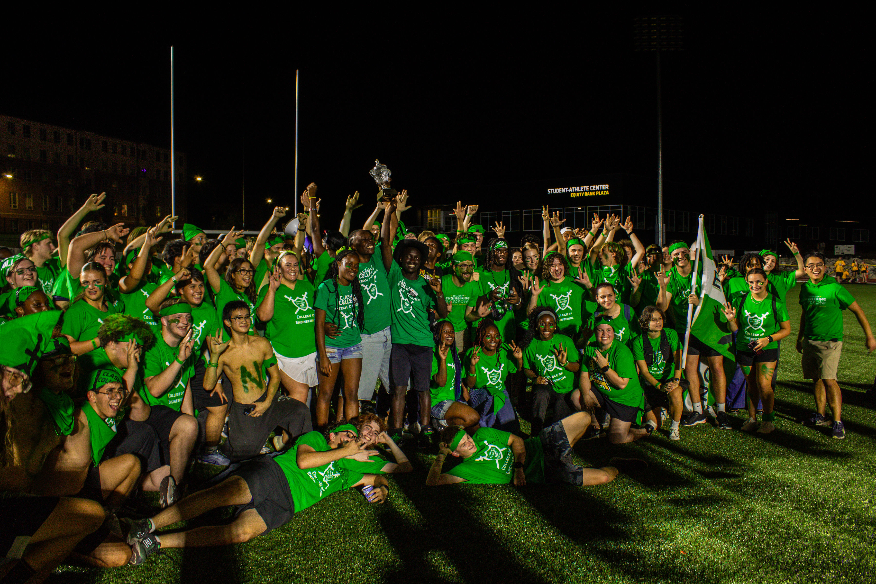 engineering students taking a picture with the clash trophy