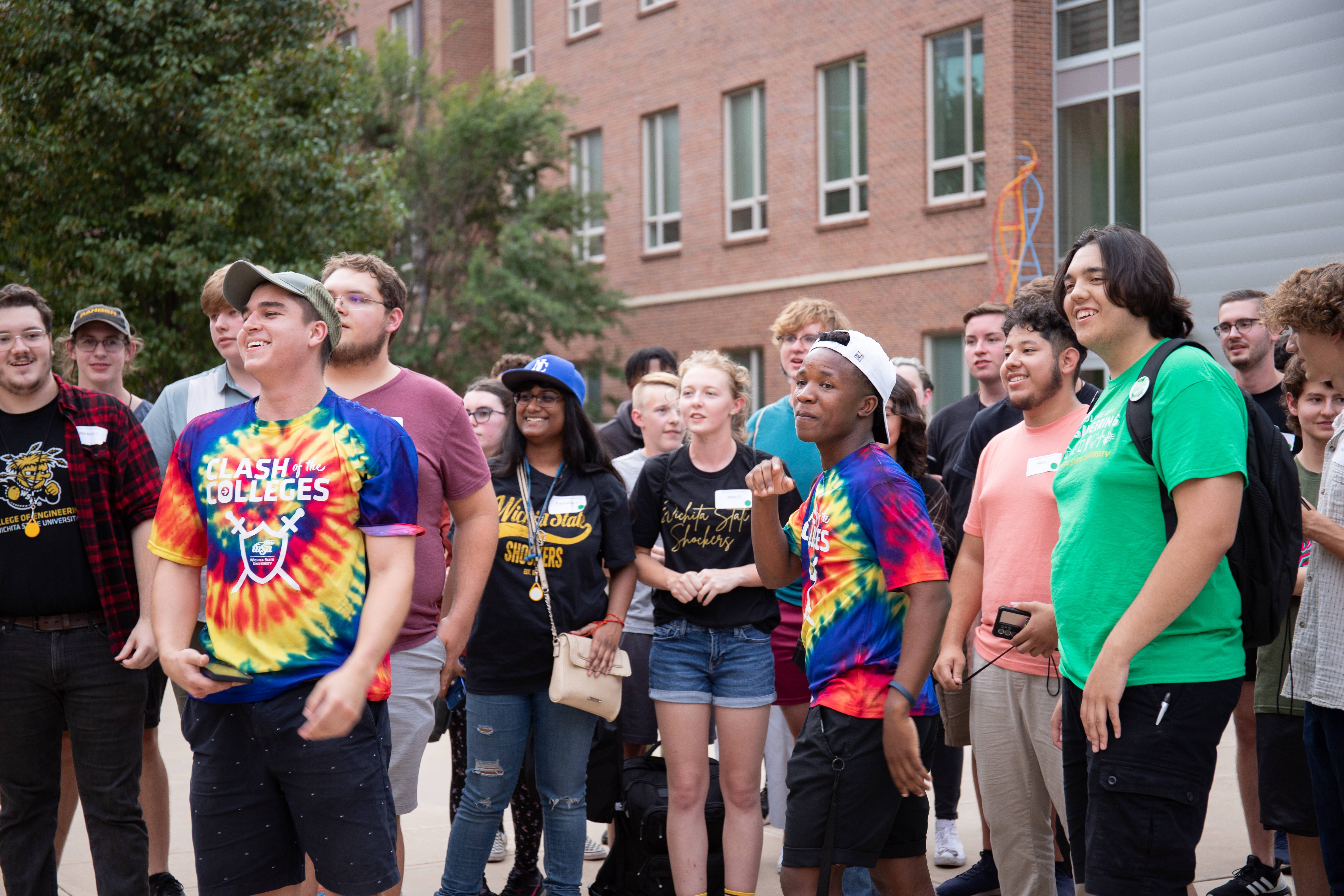 A group of students is playing an icebreaker at orientation.