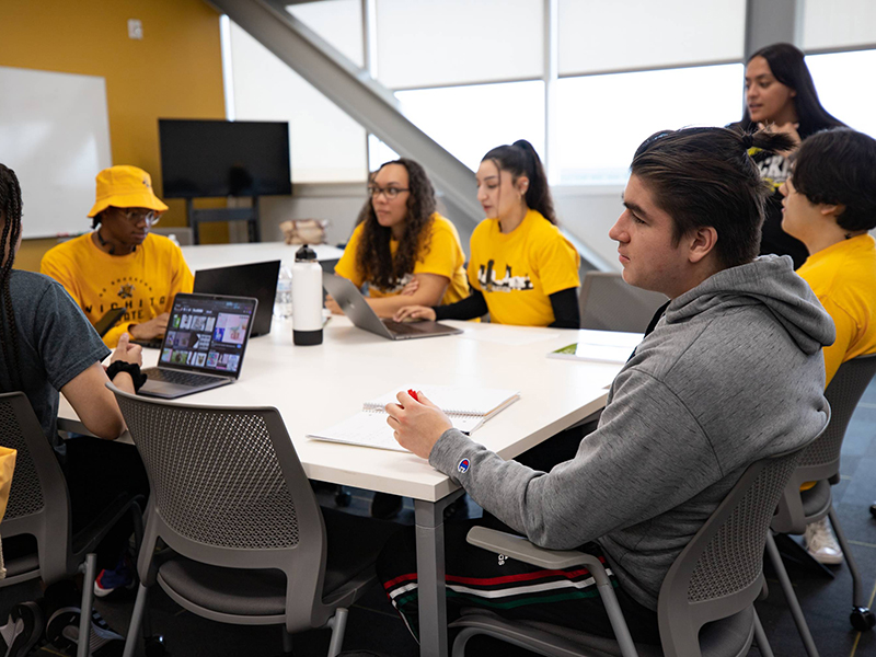 Orientation leaders gather around a table in John Bardo Center