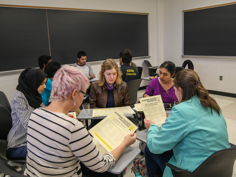 A group of students seated at a classroom table.