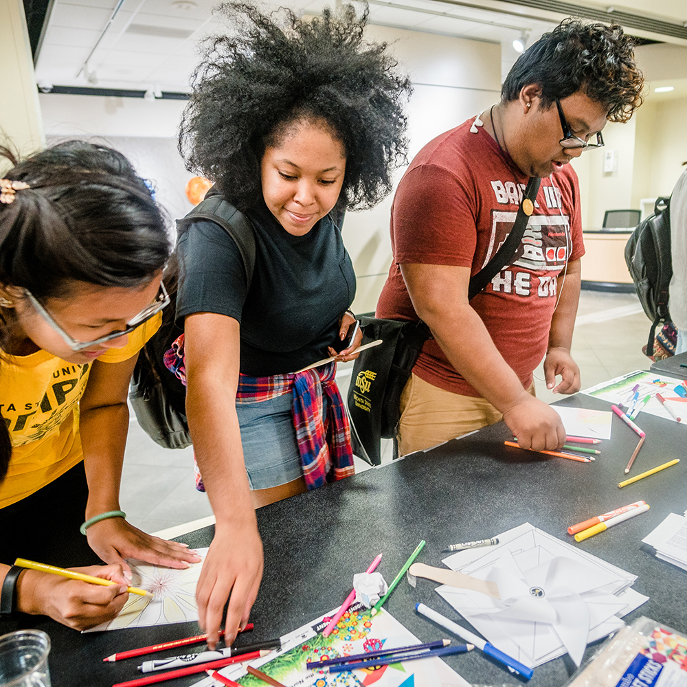 students at an information table