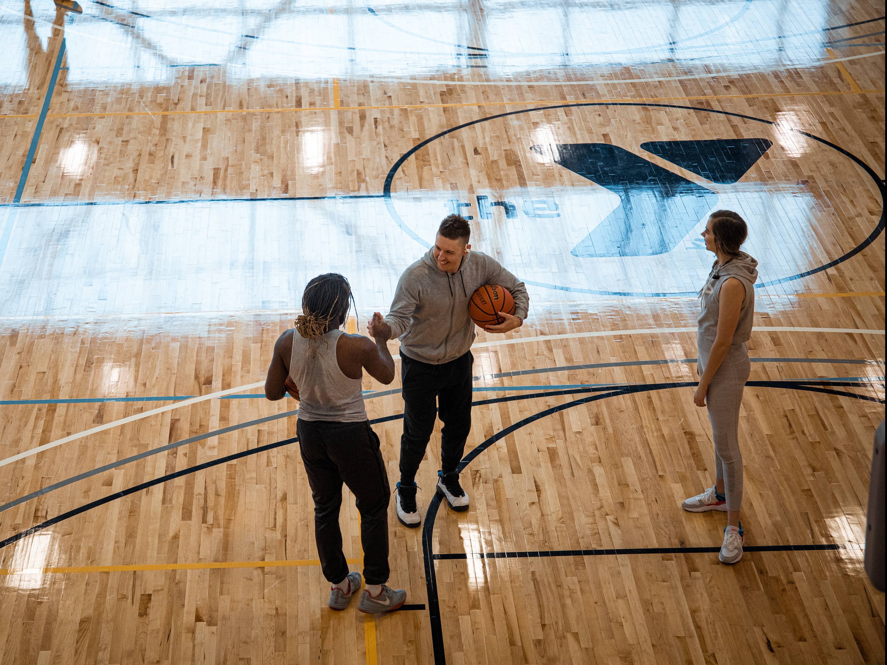 Students playing basketball at the Steve Clark YMCA & Student Wellness Center.