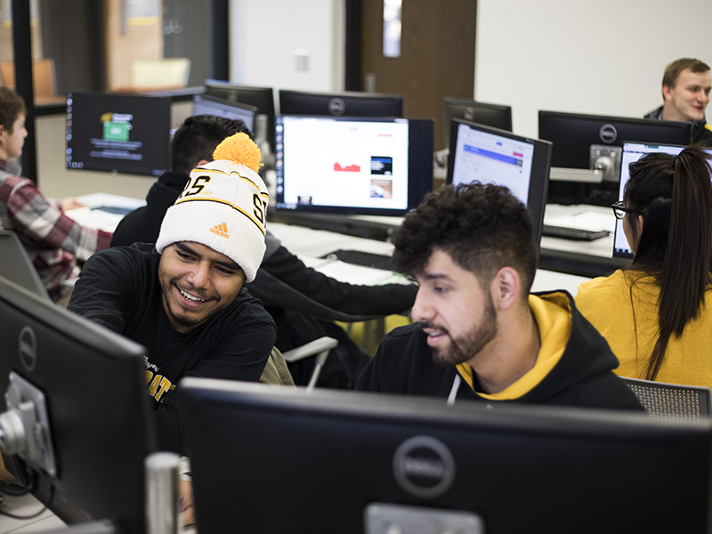 Business students working on a project in a computer lab