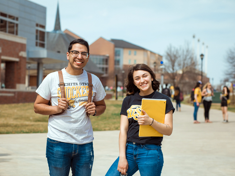 Students modeling WSU apparel outside the Rhatigan Student Center