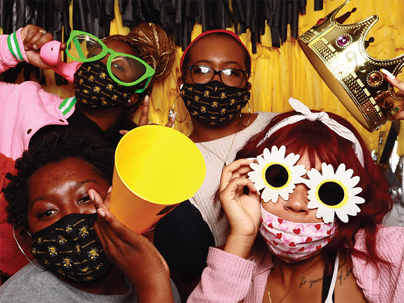 Students pose in a photo booth at an involvement event