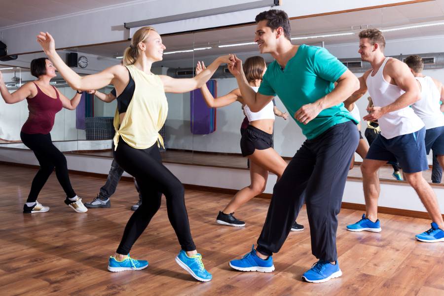 People swing dancing in a dance studio
