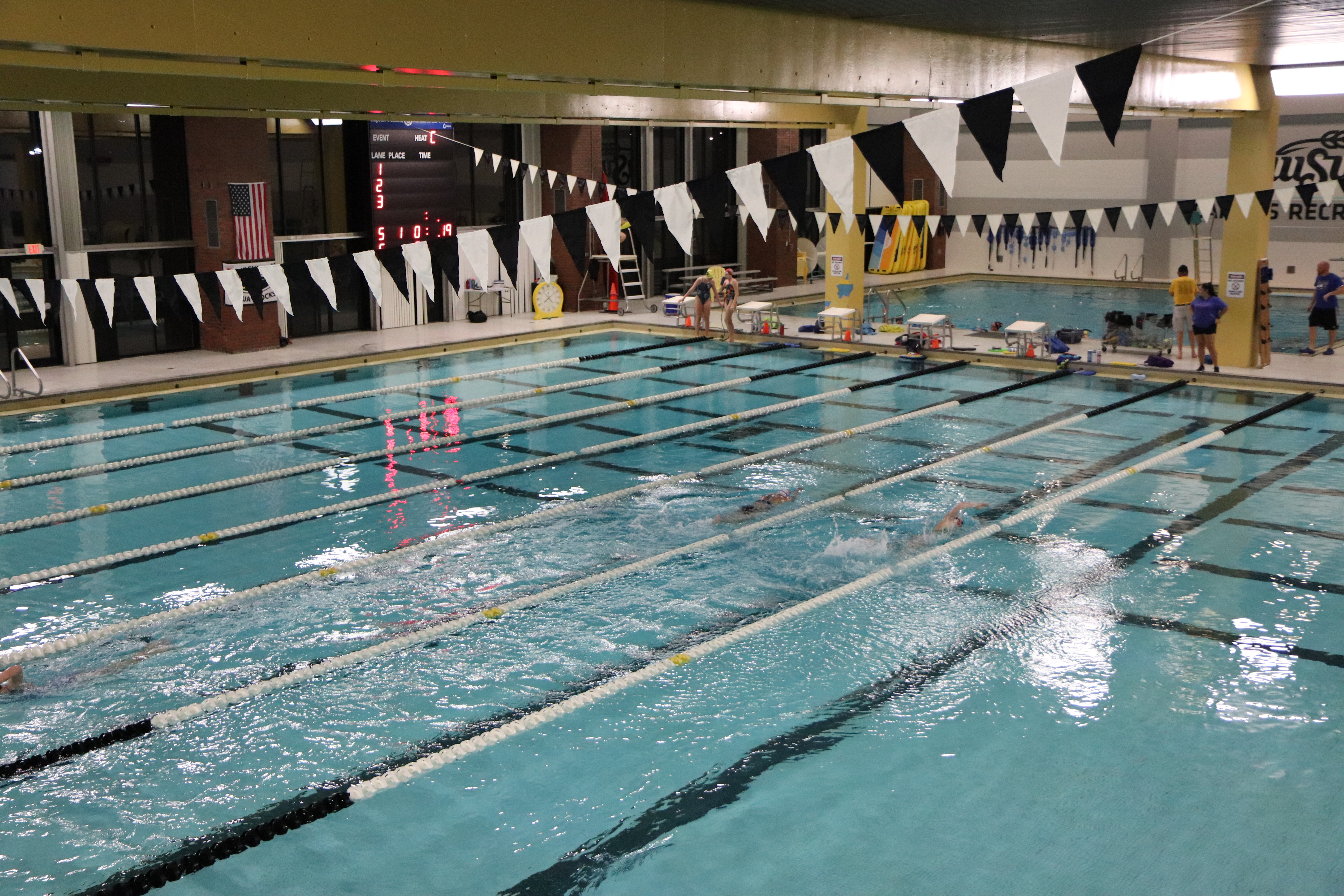 woman treading water, facing away, in the midst of jumbled lane lines