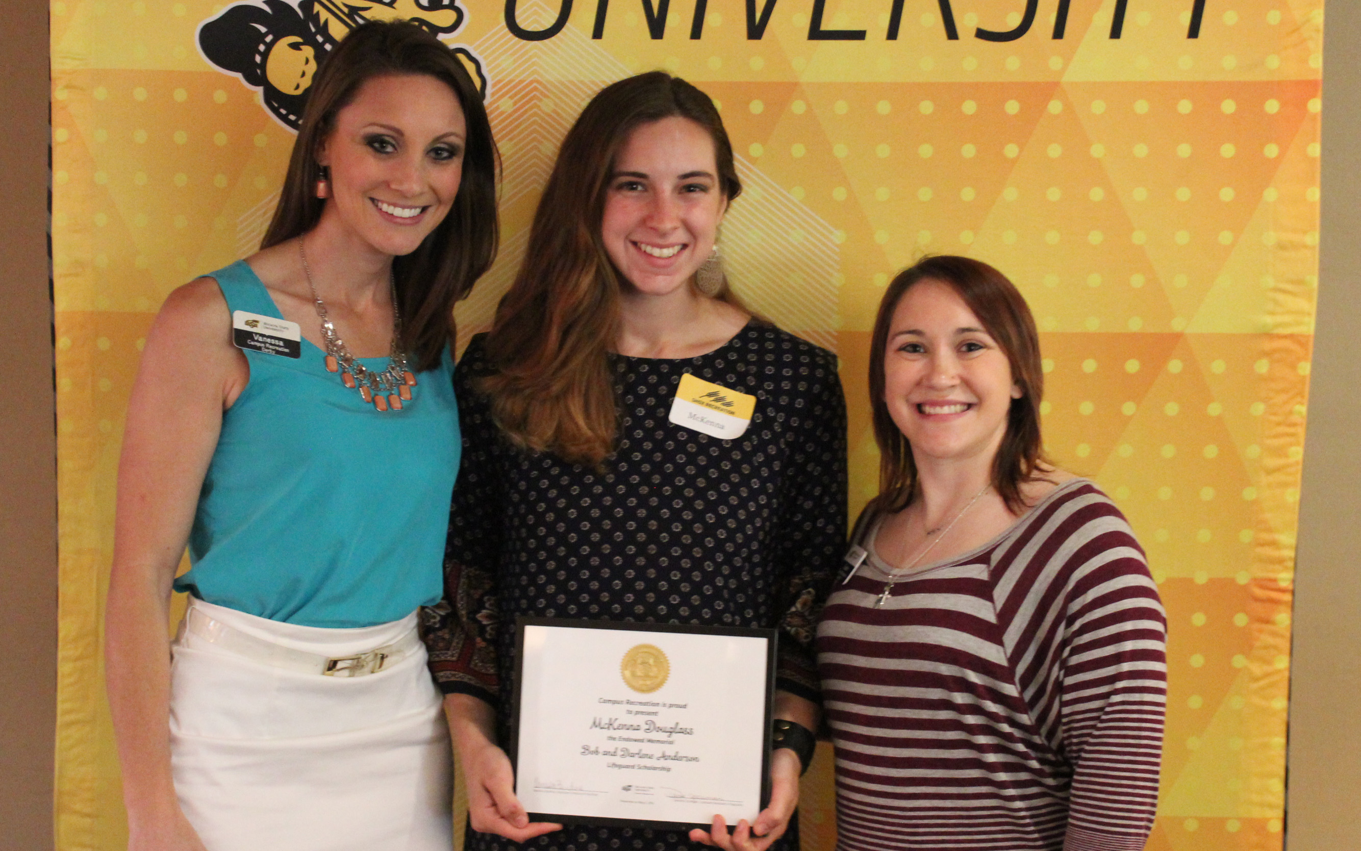 Three women with an award