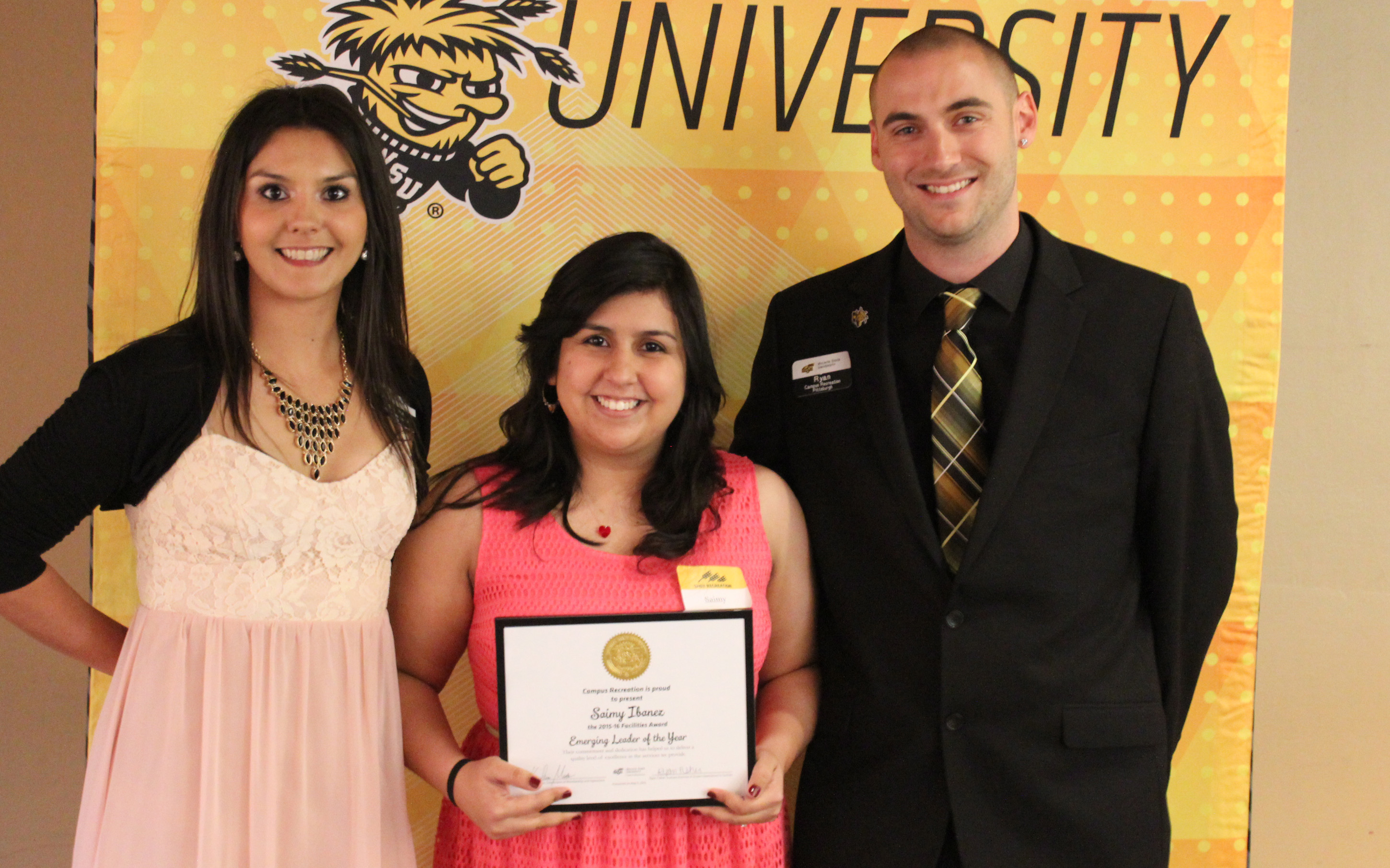 Three people with an award