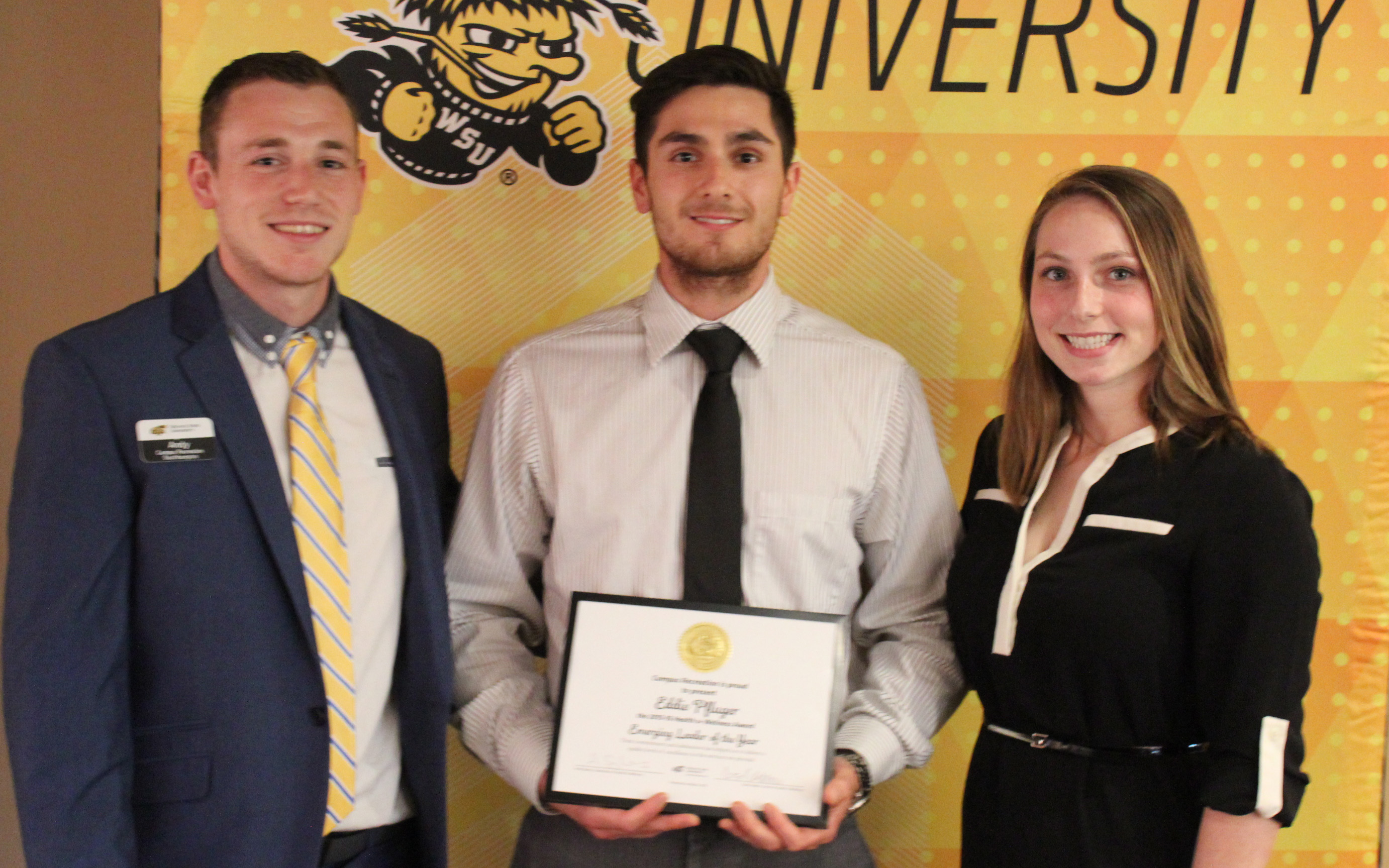 Three people with award
