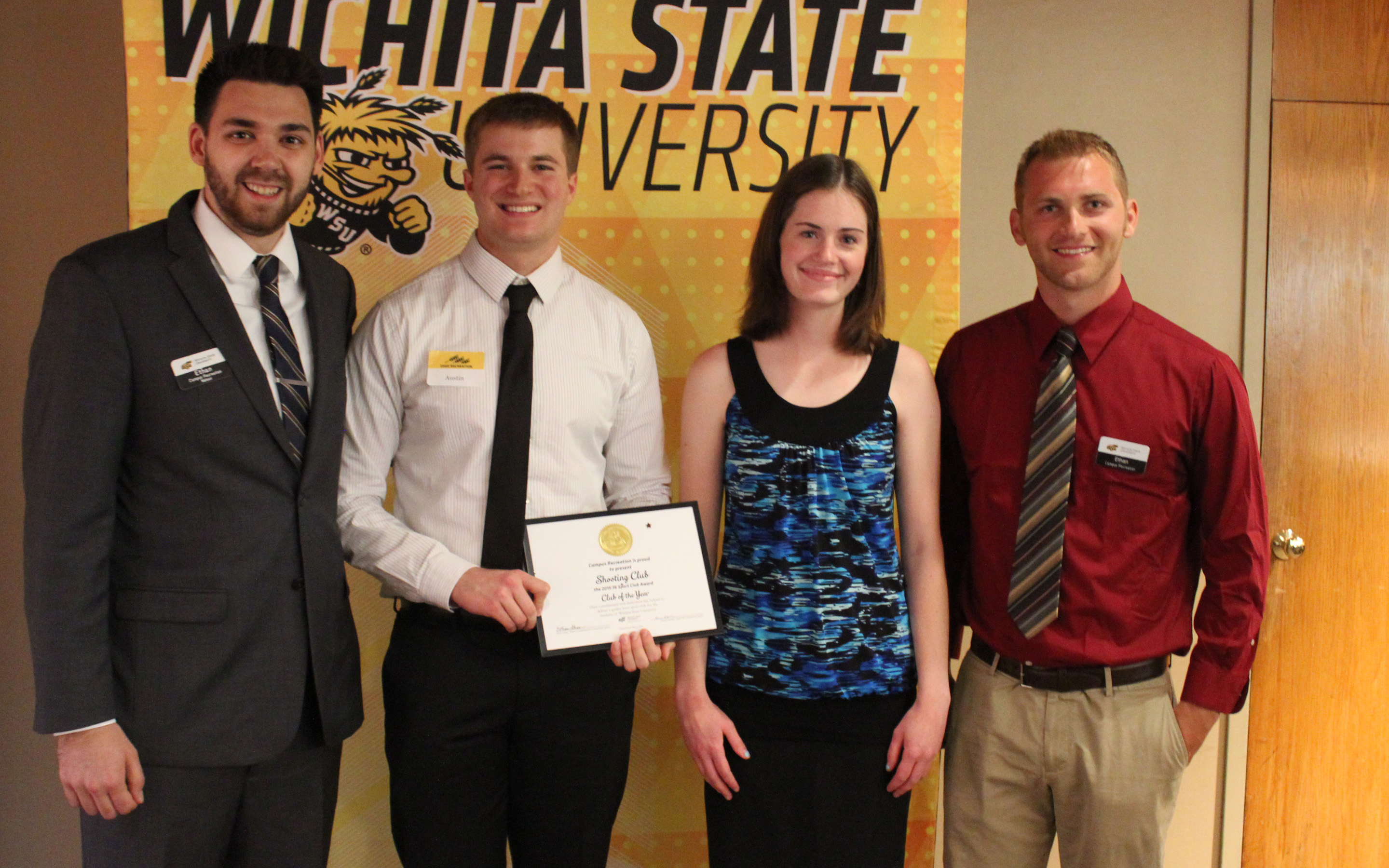 Four people with award