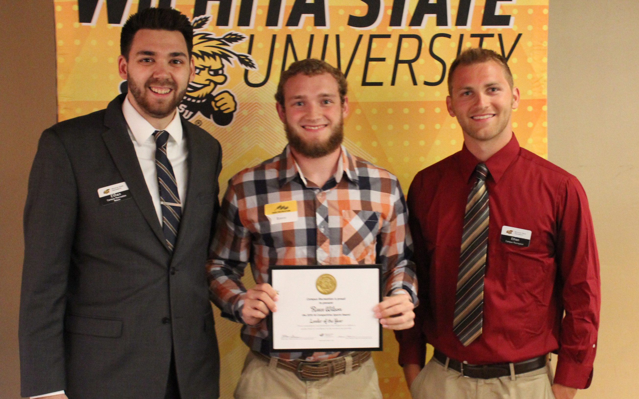 Three people with award