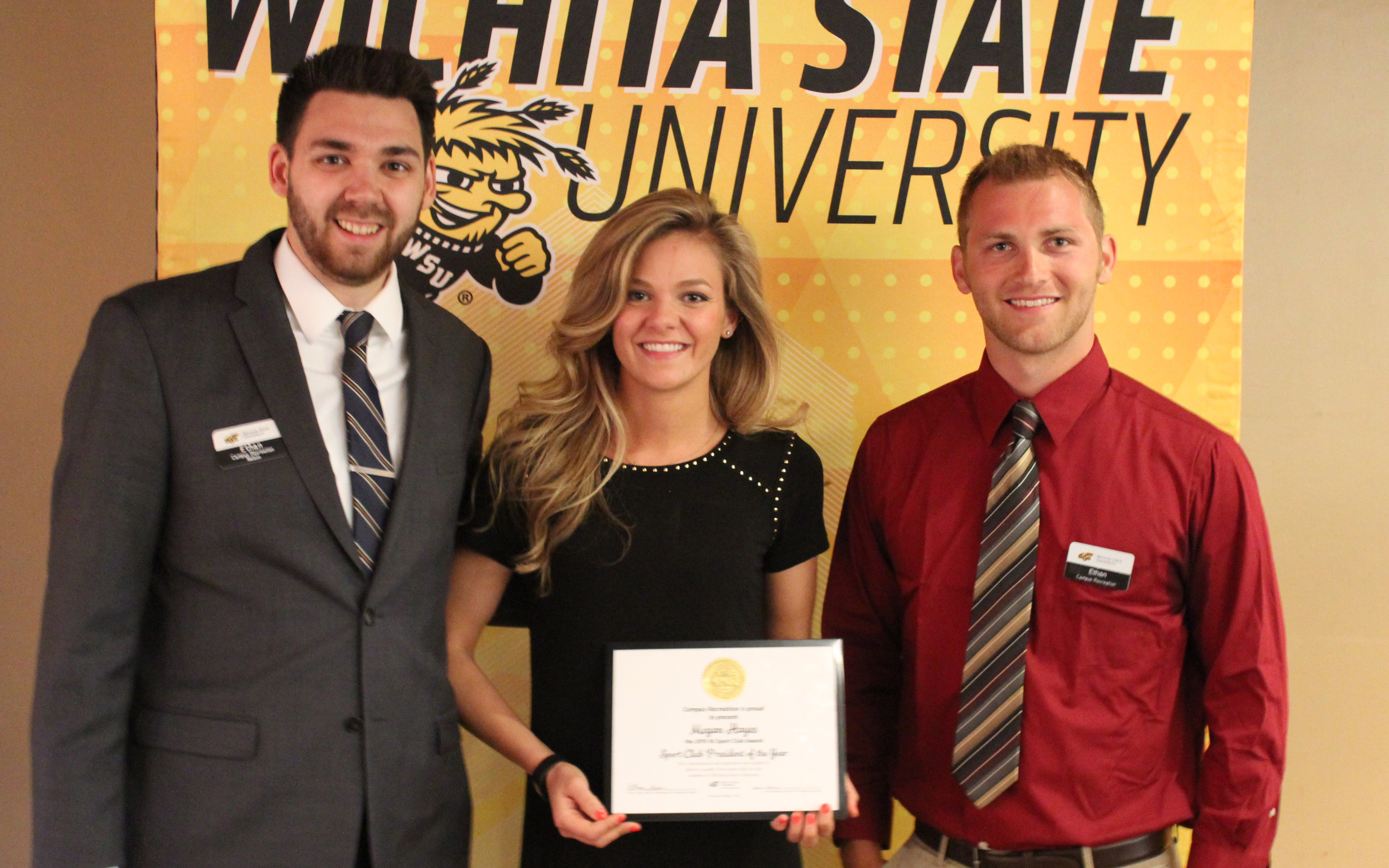 Three people with award