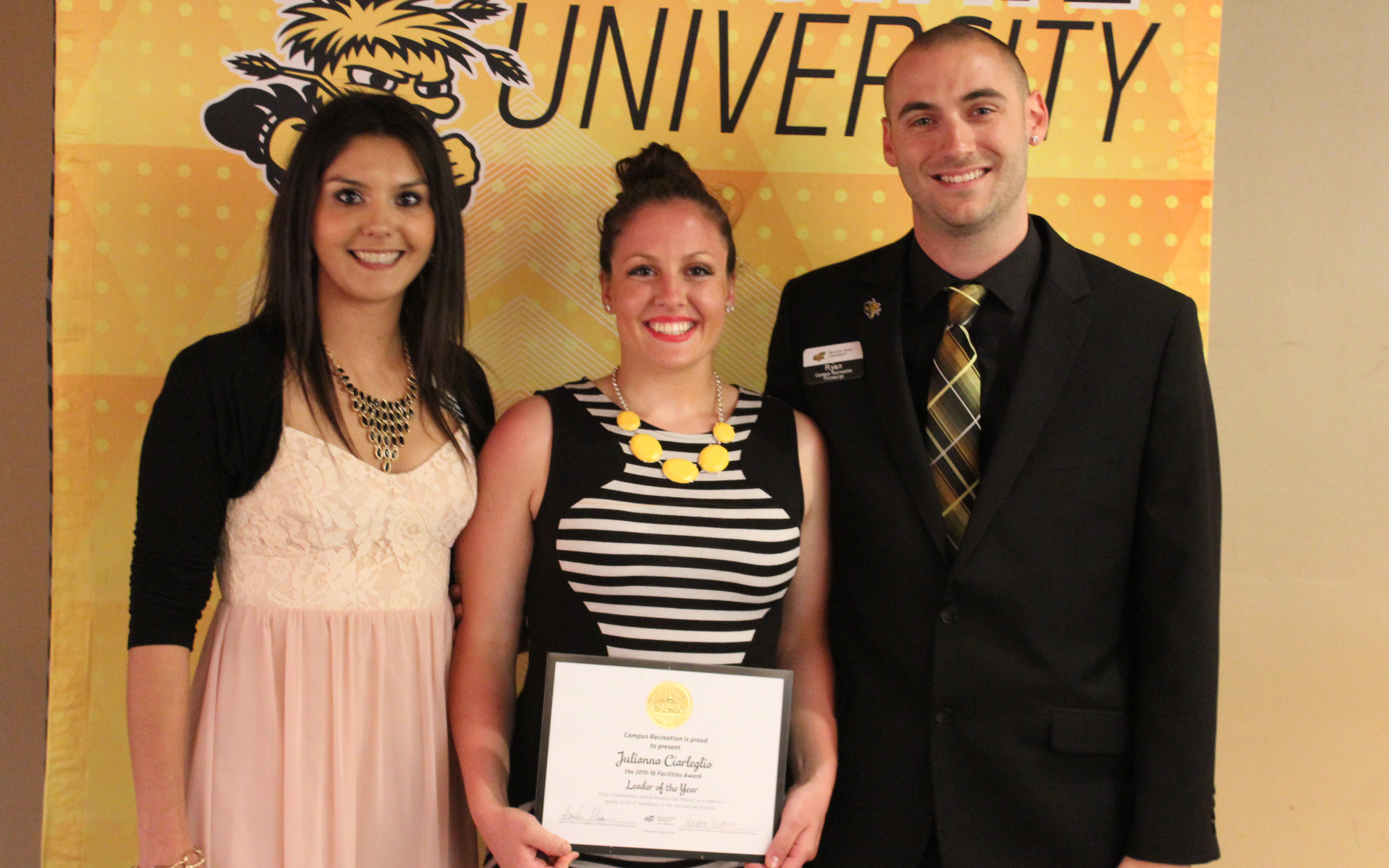 Three people with award