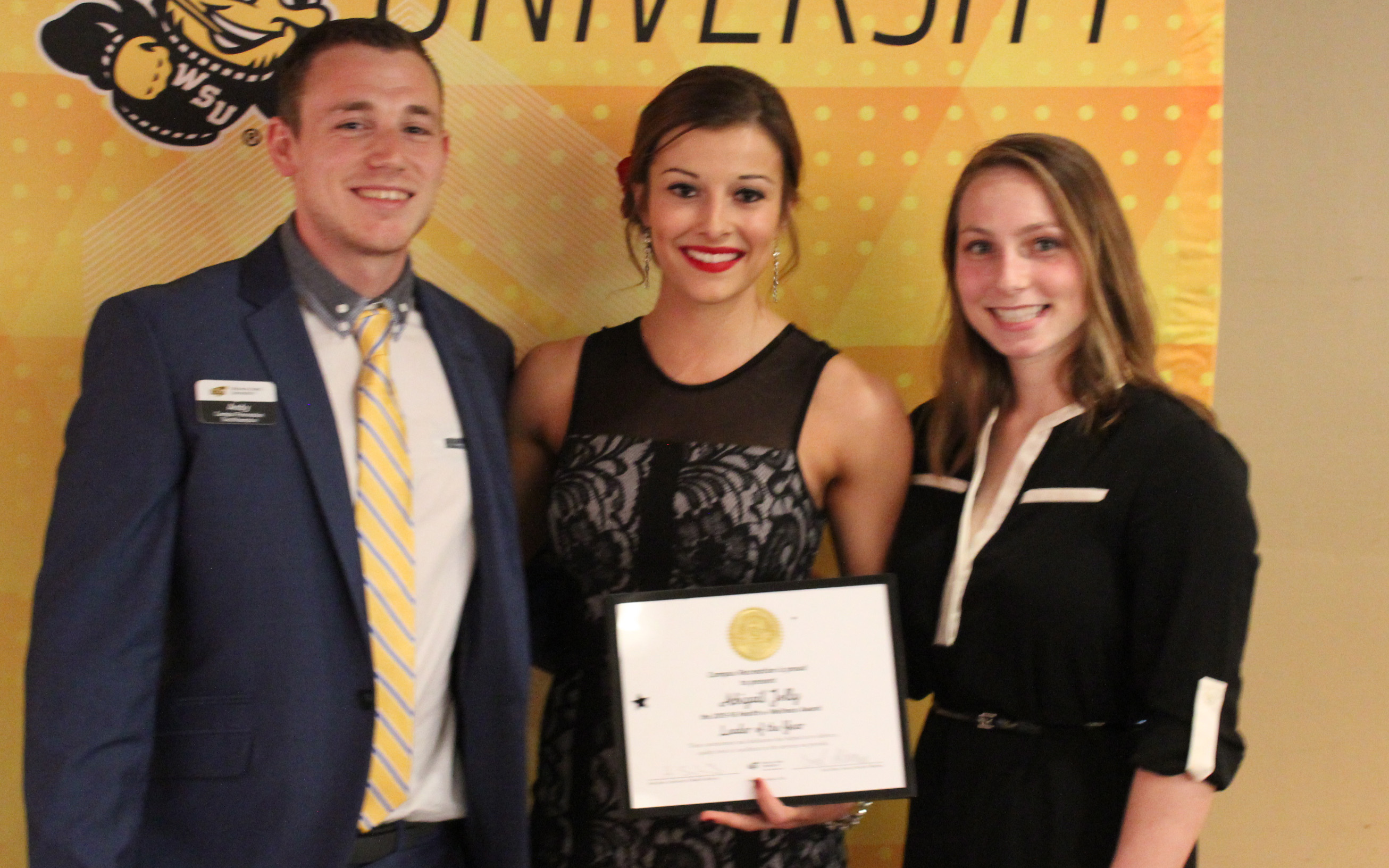 Three people with award