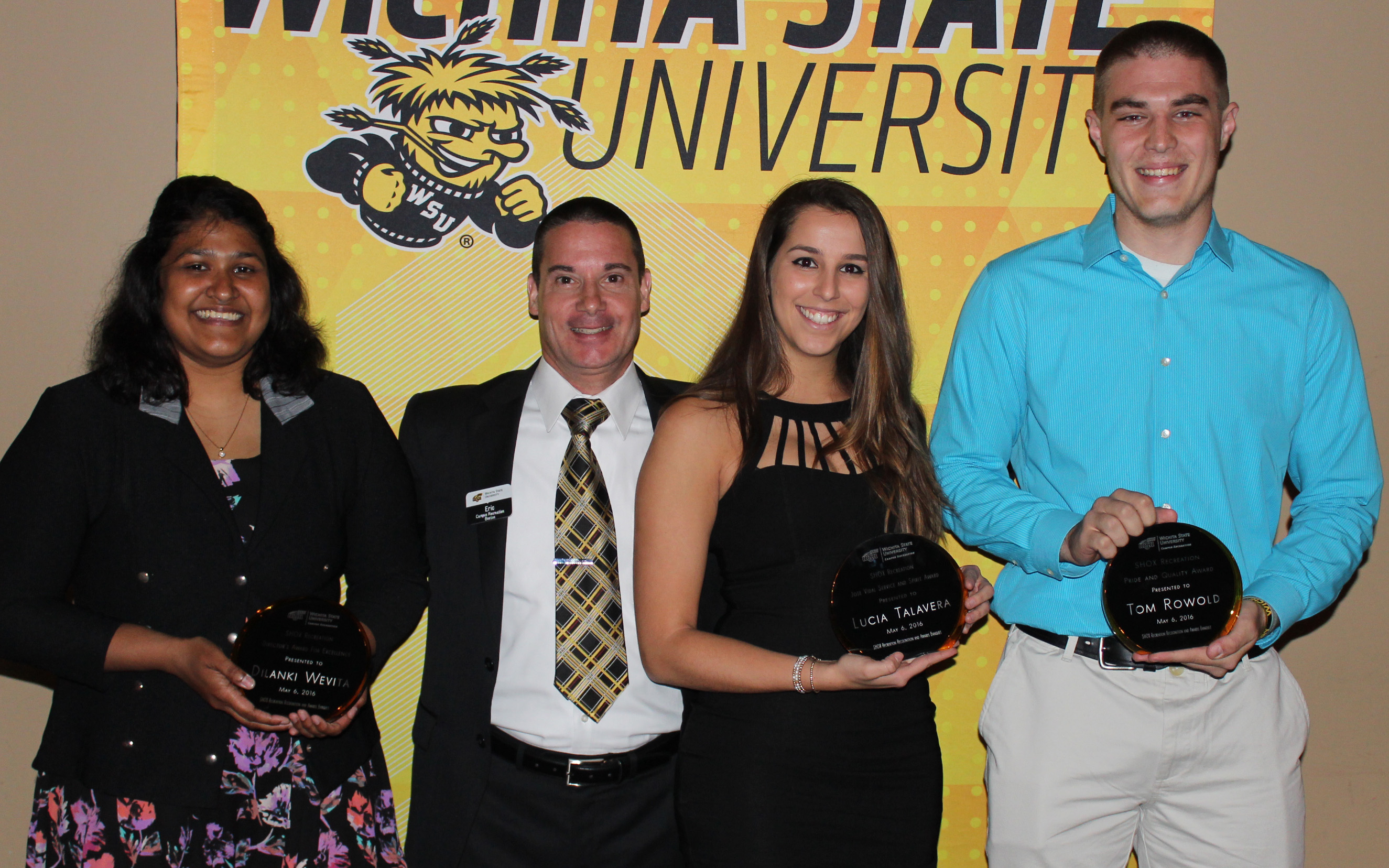 Four people with two awards