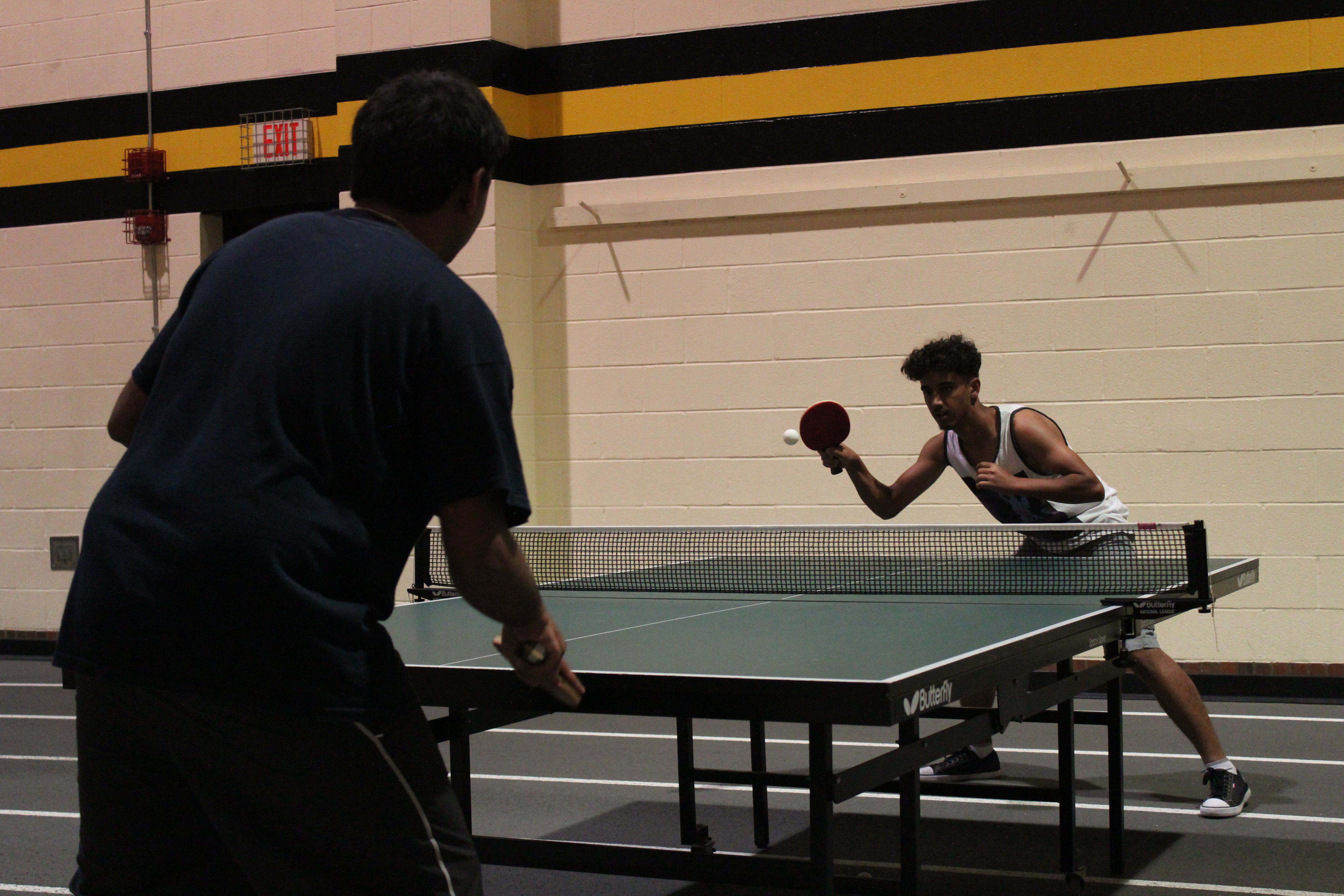 two students playing ping pong
