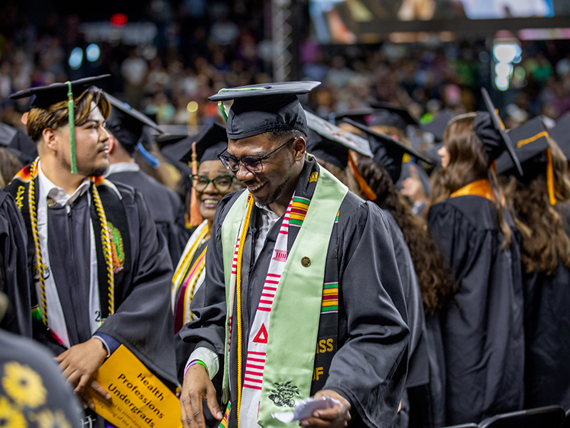 Wichita State graduate smiles at commencement.