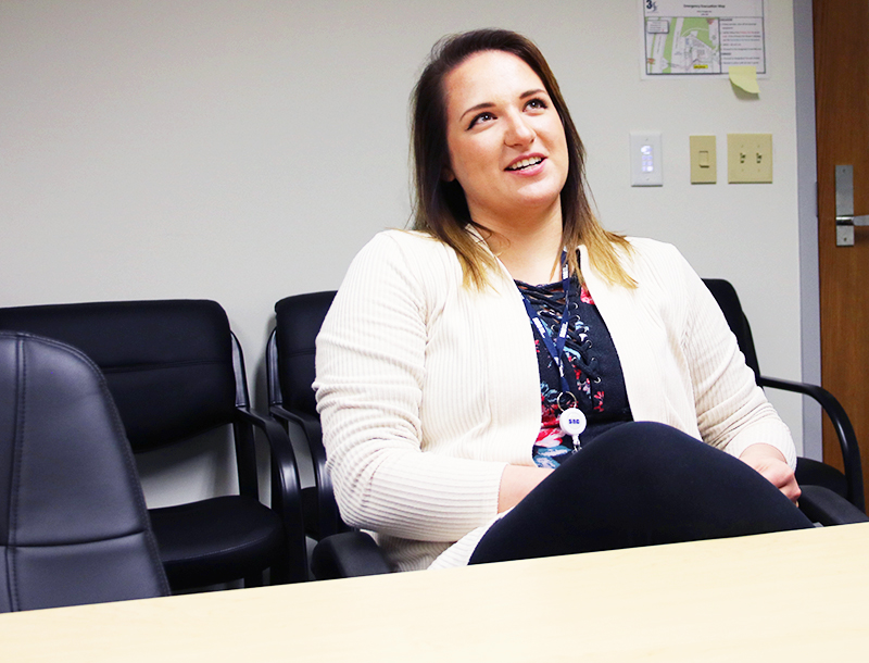 Andrea Navarro sitting at a conference table during her interview.