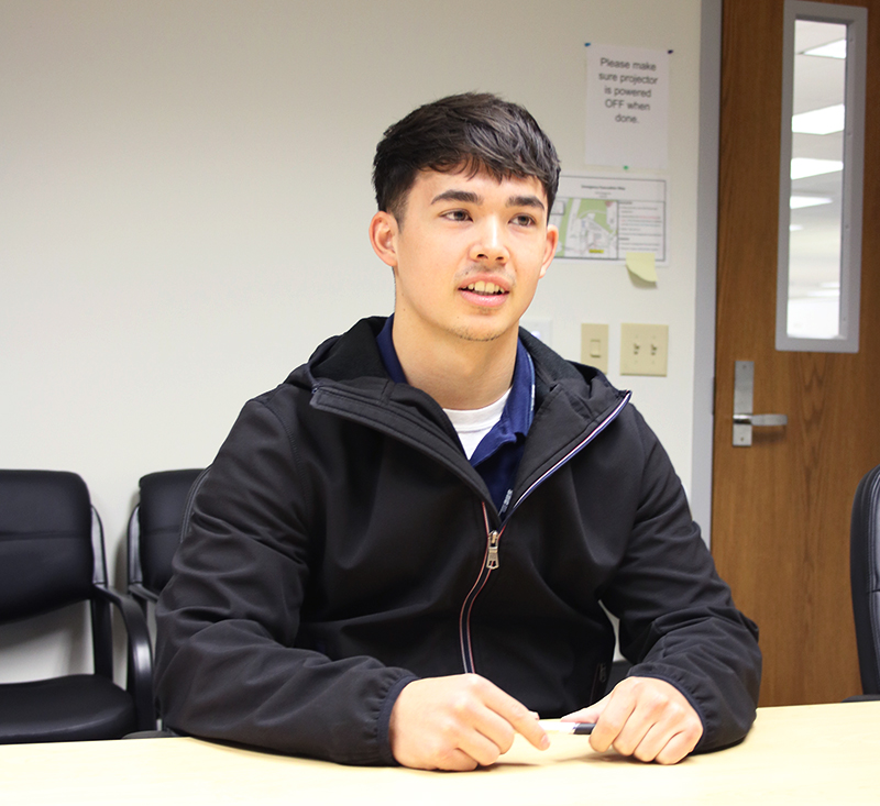 Brayden Singer during his interview sitting at a conference table.