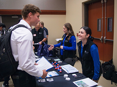 Student talks to employer at the engineering and IT career fair.