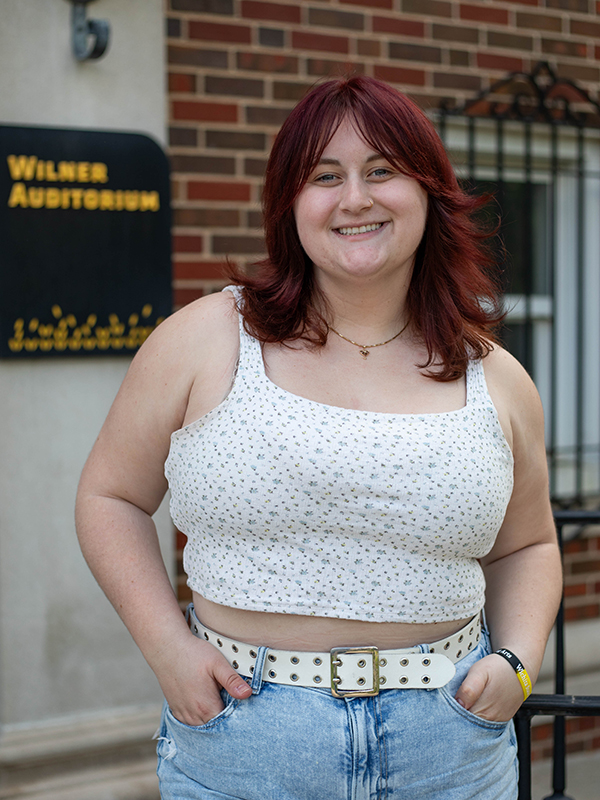 Alexandra Enmark stands outside of Wilner Auditorium where she works as a student intern in the School of Performing Arts.