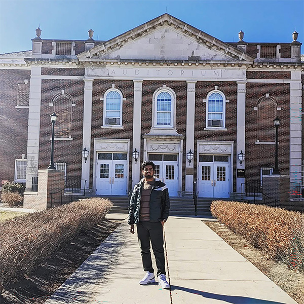 Golam Morshed Khan standing in front of an auditorium