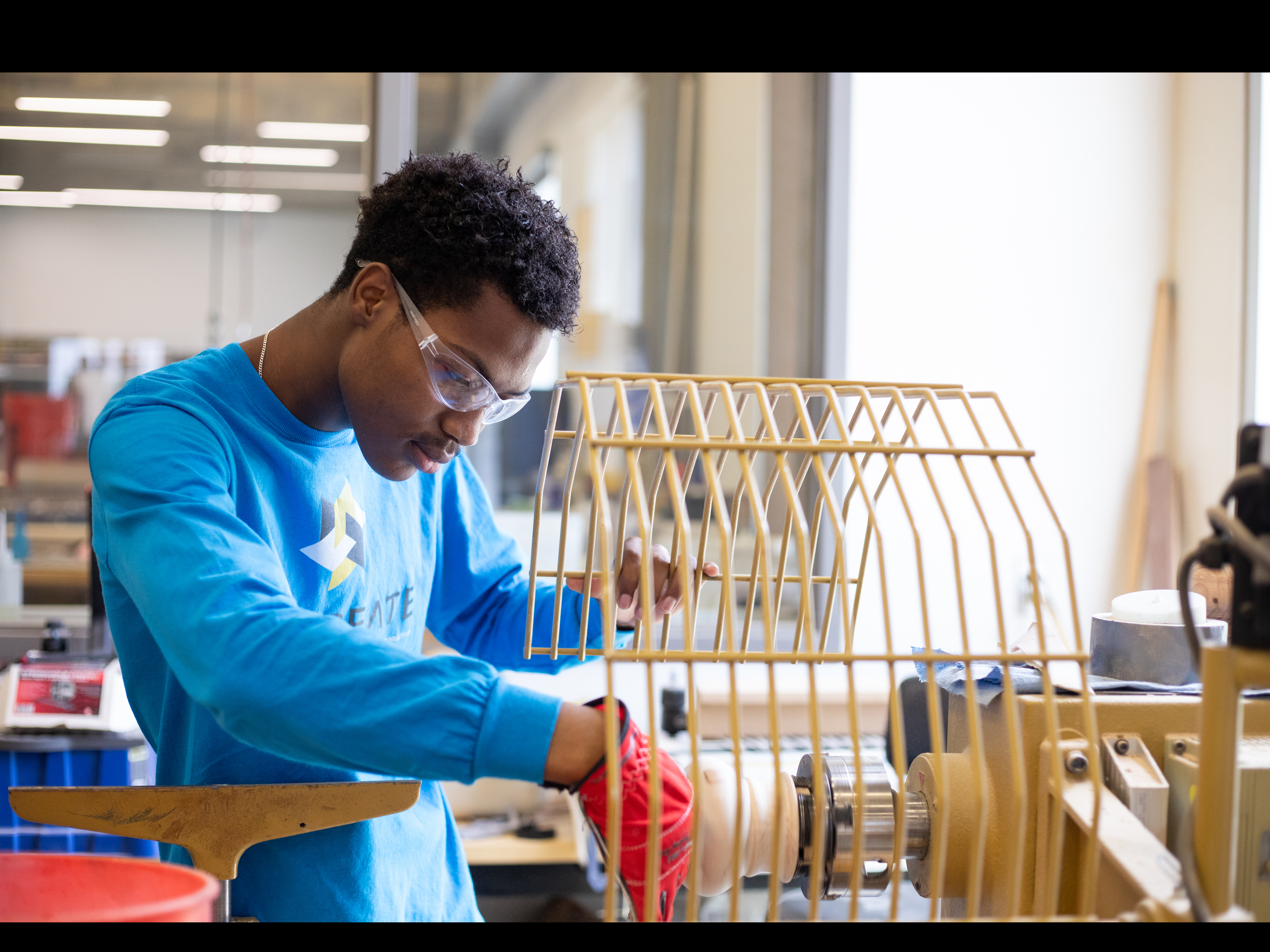 Student worker using machinery at GoCreate