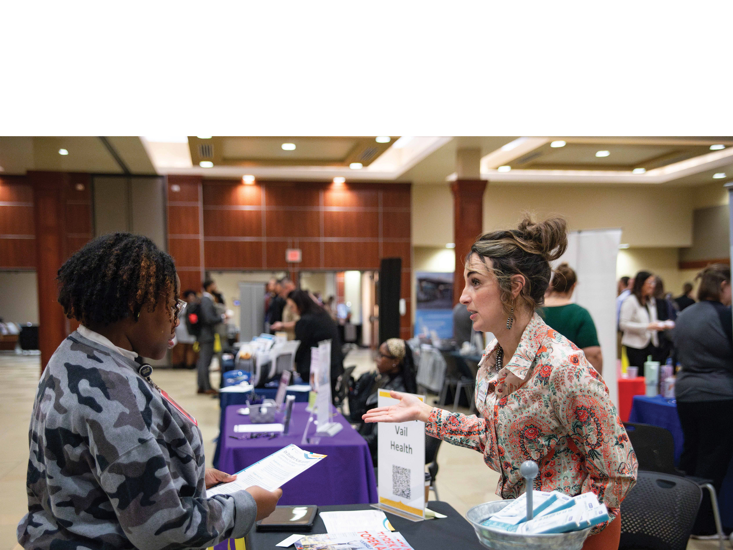 A student talks to an employer at a Shocker Career Accelerator career fair.