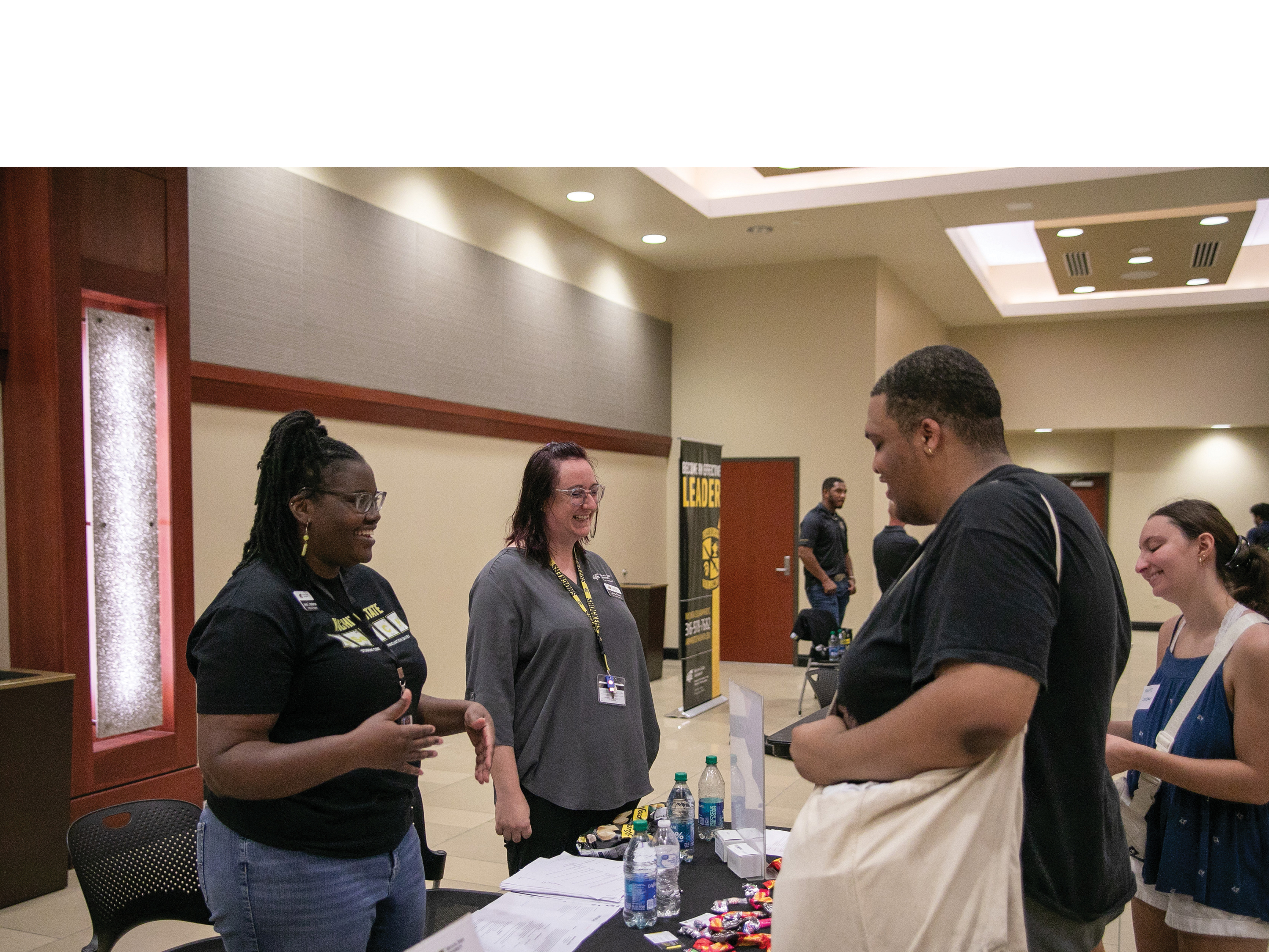 Image of Wichita State staff talking to a student at the on-campus job fair.