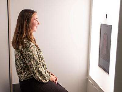 Wichita State student using the Shocker Career Accelerator photo booth to take professional headshots.