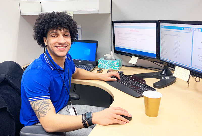 Jordan Glover in his cubicle at his computer at 3S.