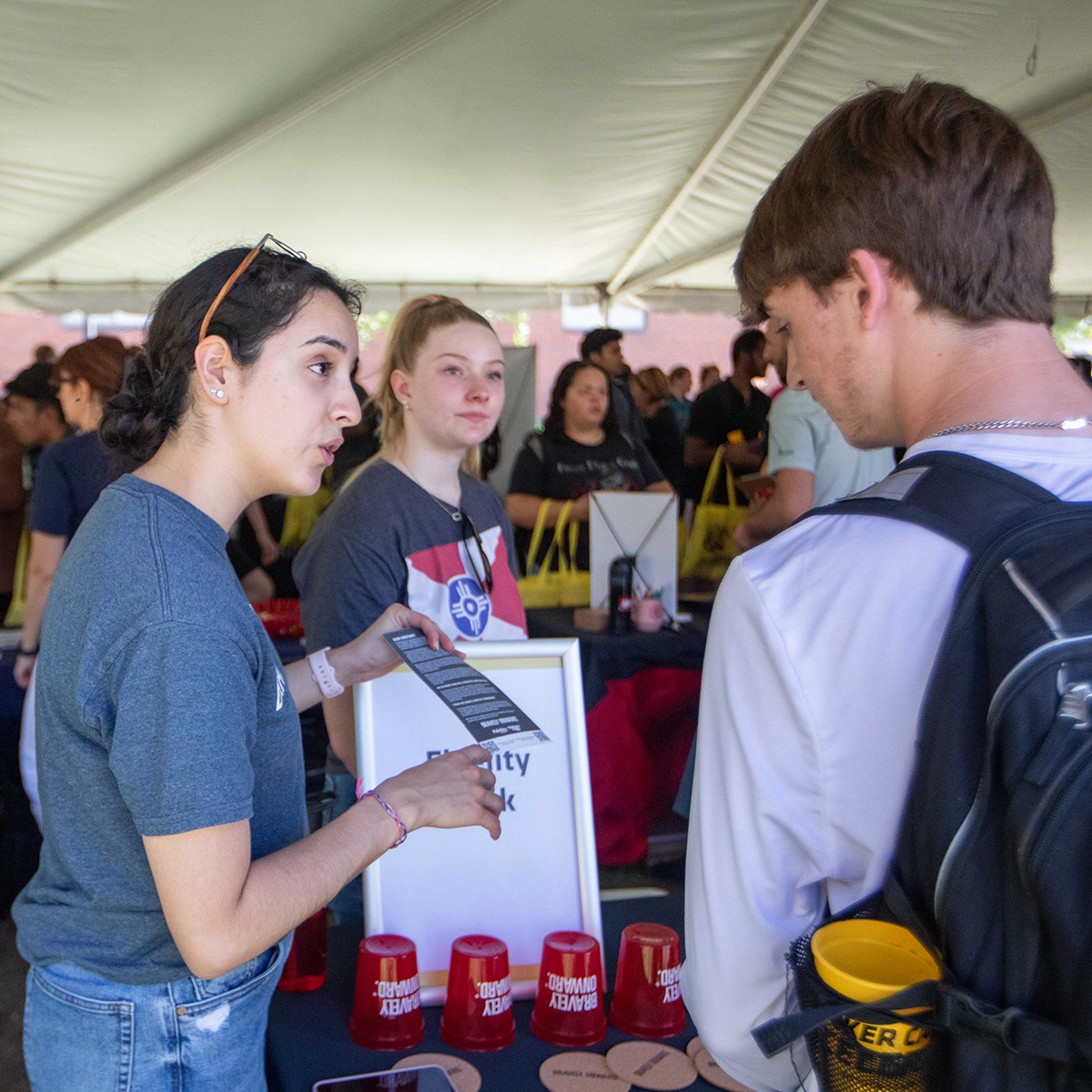 Fidelity Bank recruiter talks to a student at the Career Connections Root Beer Kegger.