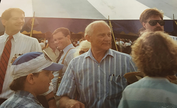Humphries escorting Buzz Aldrin through crowd.
